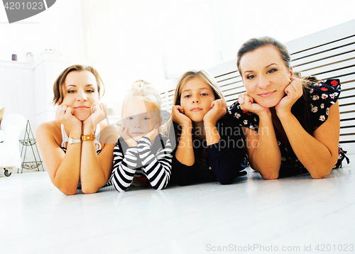 Image of Mature sisters twins at home with little daughter, happy family 