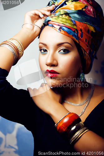 Image of beauty bright african woman with creative make up, shawl on head