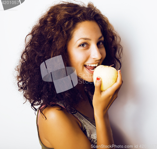 Image of pretty young real tenage girl eating apple close up smiling