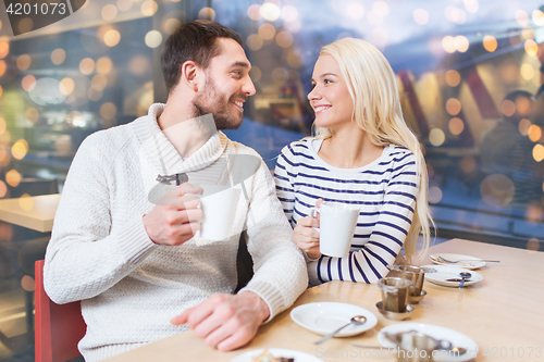 Image of happy couple meeting and drinking tea