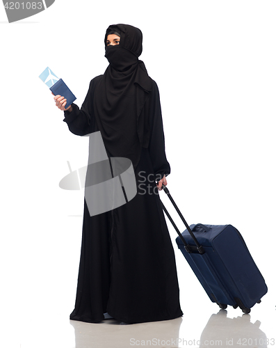 Image of muslim woman with ticket, passport and travel bag