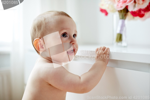 Image of happy little baby boy or girl at home