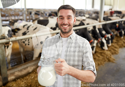 Image of man or farmer with cows milk on dairy farm