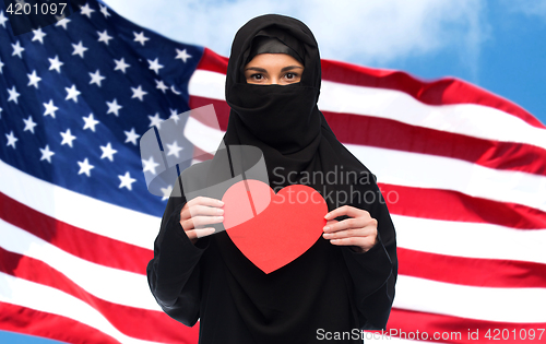 Image of muslim woman in hijab holding red heart