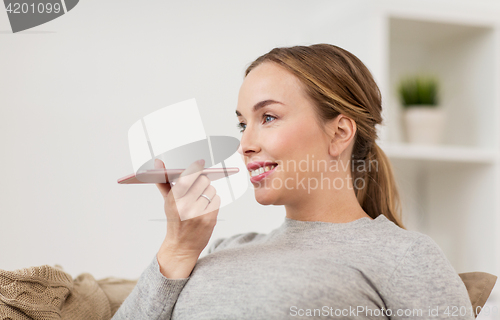 Image of woman using smartphone voice command recorder