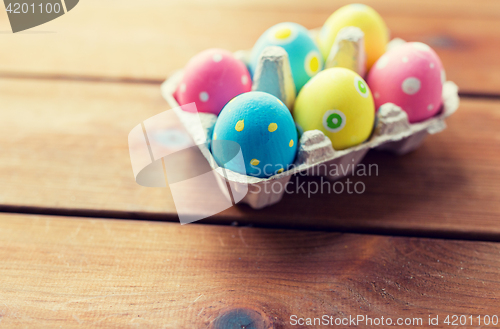 Image of close up of colored easter eggs in egg box