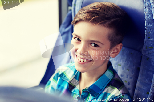 Image of happy boy sitting in travel bus or train