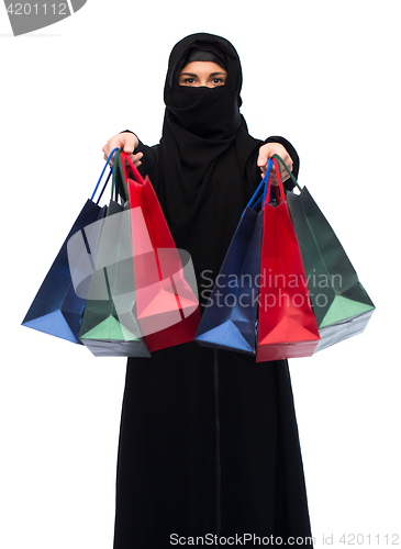 Image of muslim woman in hijab with shopping bags