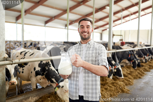 Image of man or farmer with cows milk on dairy farm