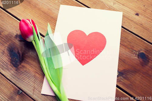 Image of close up of flowers and greeting card with heart