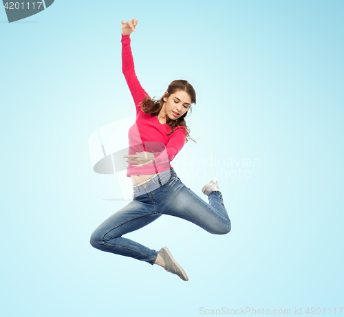 Image of smiling young woman jumping in air