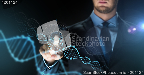 Image of businessman with virtual dna molecule projection