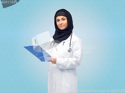 Image of muslim female doctor in hijab with clipboard