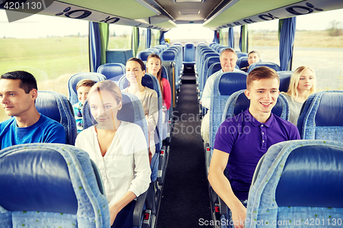 Image of group of happy passengers in travel bus