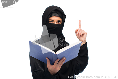 Image of muslim woman in hijab with book over white