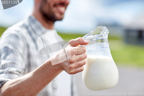Image of man or farmer with jug of milk at countryside