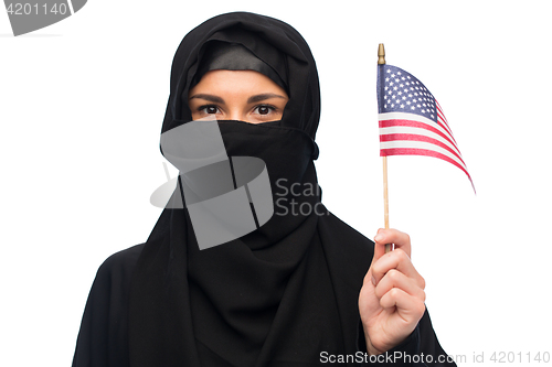 Image of muslim woman in hijab with american flag