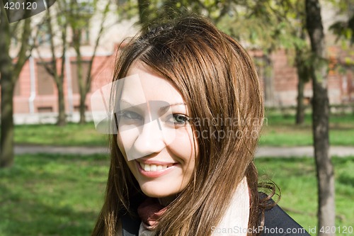 Image of Portrait of the smiling nice girl outdoor
