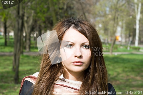 Image of Portrait of the sad nice girl outdoor