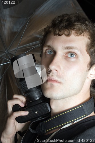 Image of The young man – photographer with digital camera