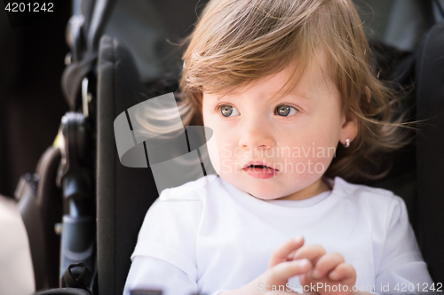 Image of baby girl sitting in the pram