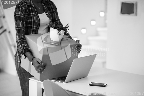 Image of Black girl moving in the new apartment