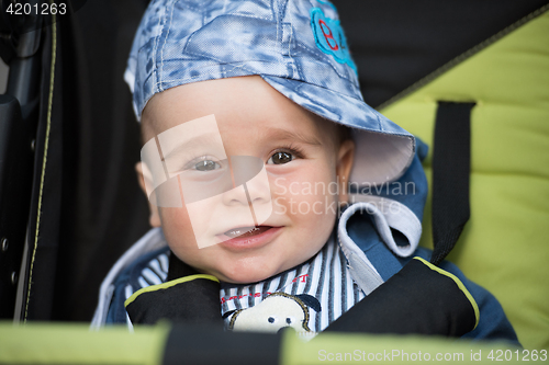 Image of baby boy sitting in the pram