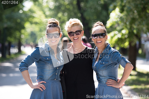 Image of portrait of three young beautiful woman with sunglasses