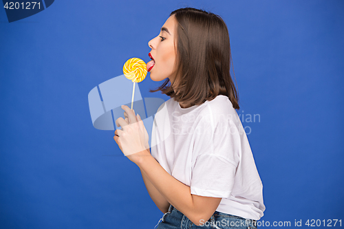 Image of The young woman with colorful lollipop