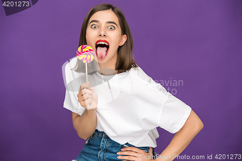 Image of The young woman with colorful lollipop