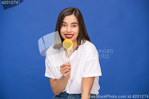 Image of The young woman with colorful lollipop