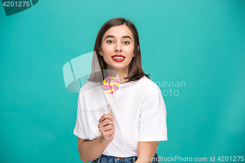 Image of The young woman with colorful lollipop