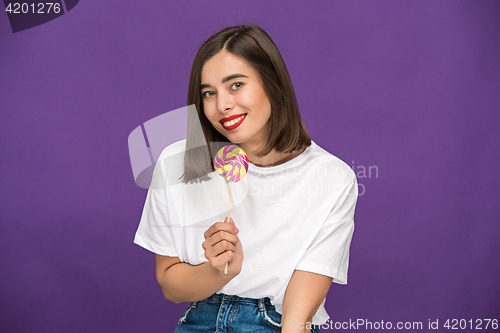 Image of The young woman with colorful lollipop