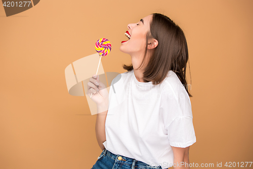 Image of The young woman with colorful lollipop