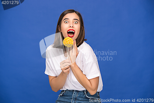 Image of The young woman with colorful lollipop