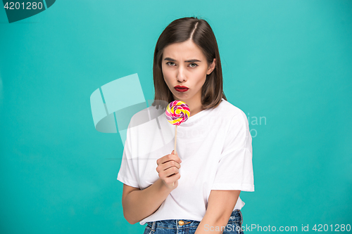 Image of The young woman with colorful lollipop