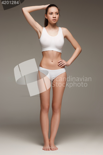 Image of Young, slim, healthy and beautiful woman in white lingerie