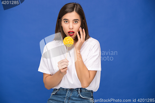 Image of The young woman with colorful lollipop