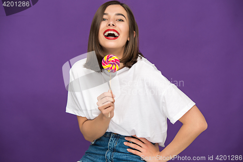 Image of The young woman with colorful lollipop