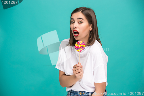 Image of The young woman with colorful lollipop