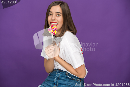 Image of The young woman with colorful lollipop