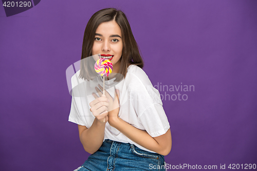 Image of The young woman with colorful lollipop