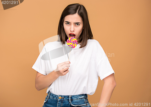 Image of The young woman with colorful lollipop