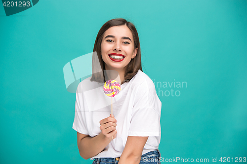 Image of The young woman with colorful lollipop