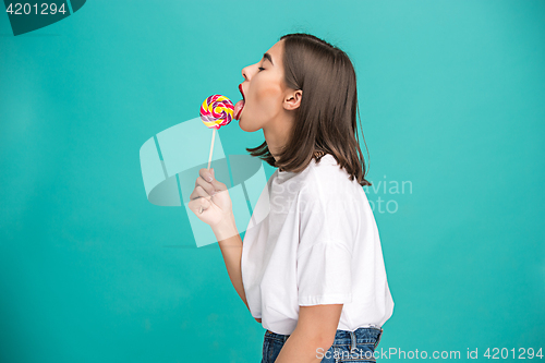 Image of The young woman with colorful lollipop