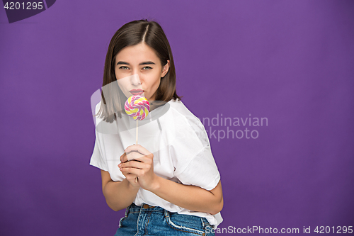 Image of The young woman with colorful lollipop