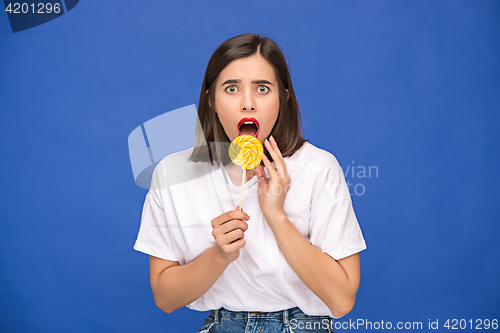 Image of The young woman with colorful lollipop