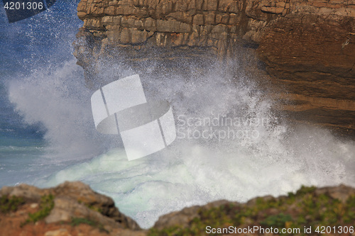 Image of Marine wave breaks against offshore stone