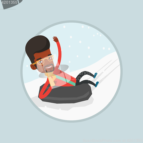 Image of Man sledding on snow rubber tube in the mountains.