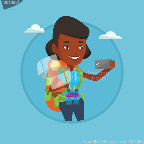 Image of Woman with backpack making selfie.